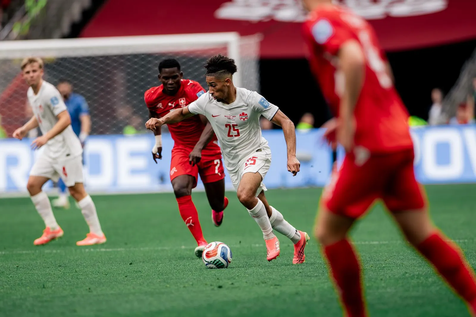 Canada's Nathan Saliba controls the ball against a Switzerland opponent in Wednesday's FIFA World Cup match in Vancouver.