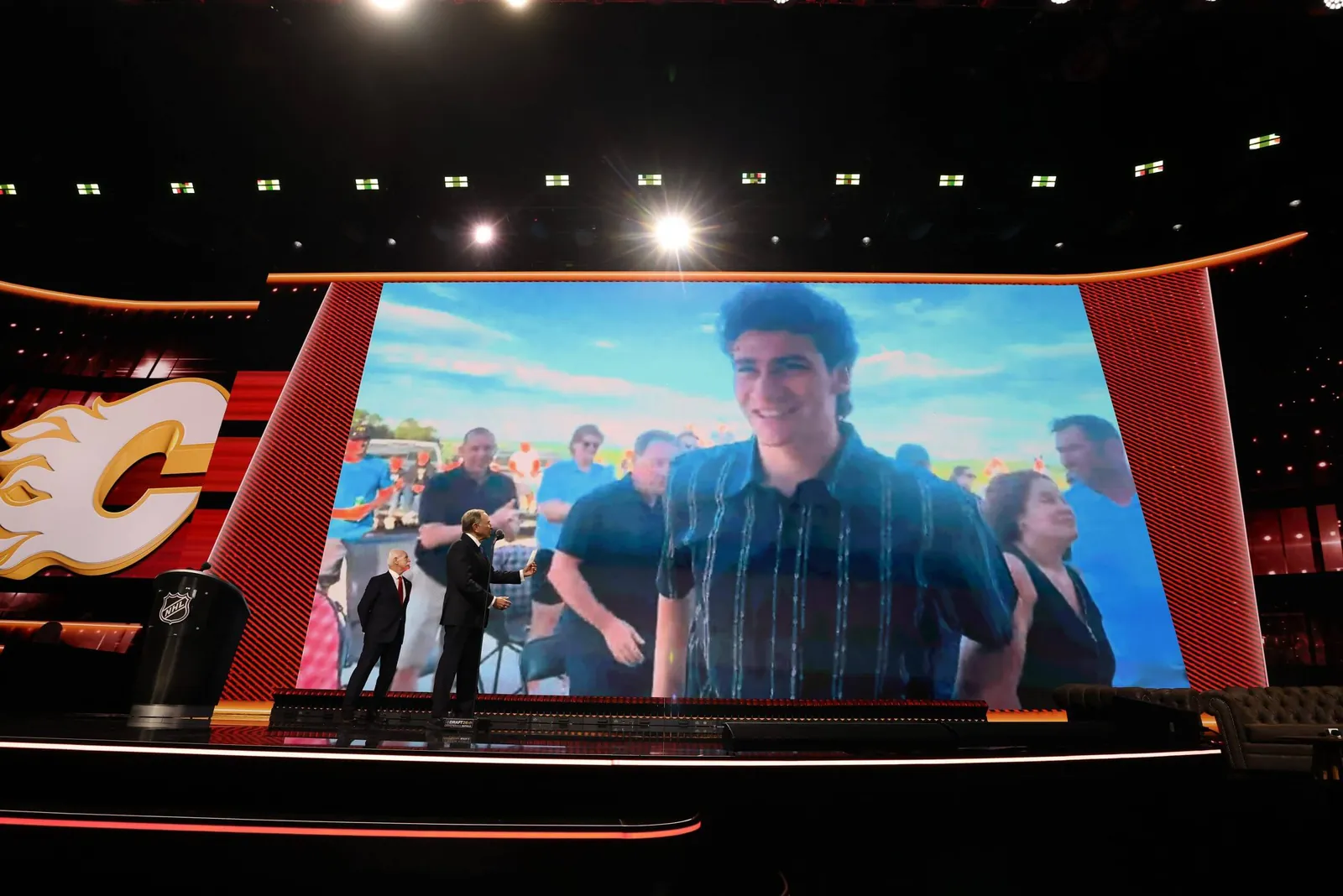 Carson Carels is shown on the screen at the NHL Draft in Buffalo after the Flames selected him at No. 5