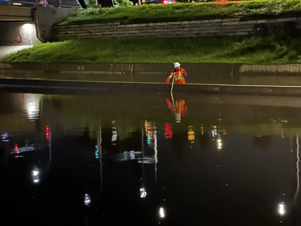 Crew member seen working near a flooded overpass by Whitemud and 159 Street after heavy rains on July 25, 2026 (CityNews)