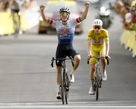Remco Evenepoel celebrates as he crosses the finish line ahead of Tadej Pogacar at Plateau de Solaison