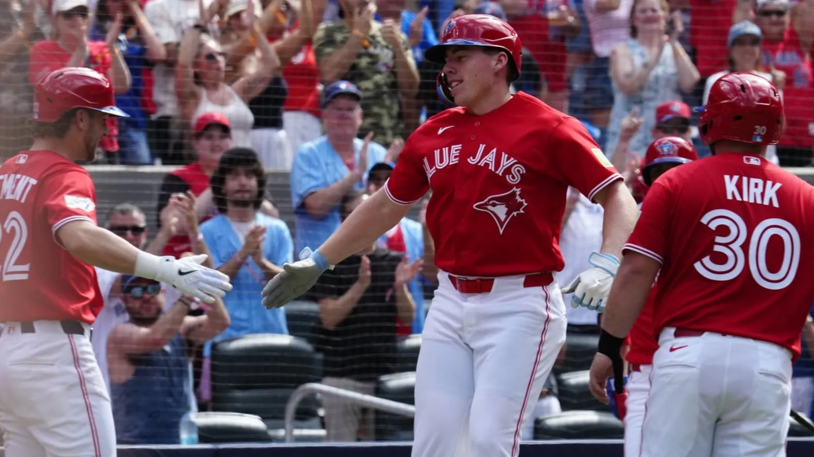 Toronto Blue Jays' Ernie Clement, left, and Alejandro Kirk congratulates Sean Keys after he hit a three run home run against the New York Mets during third inning MLB baseball action in Toronto on Wednesday, July 1, 2026. THE CANADIAN PRESS/Frank Gunn