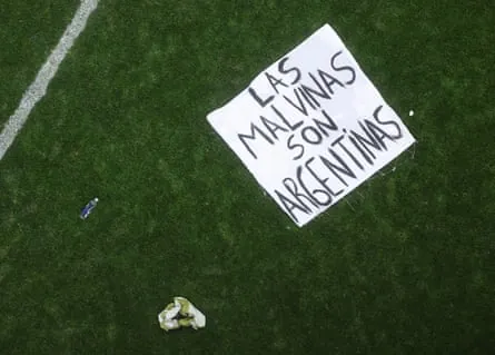 Argentina’s Malvinas banner is seen on the pitch following Argentina’s 2-1 win