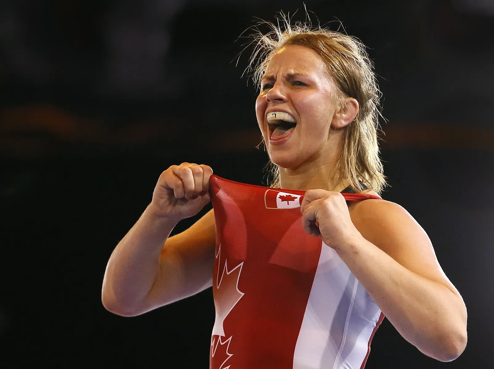 Erica Wiebe of Canada celebrates winning gold in a bout against Jyoti of India in the Nordic System 75kg wrestling bout at the Scottish Exhibition Conference Centre during the Commonwealth Games 2014 in Glasgow, Scotland, Tuesday July 29, 2014. (AP Photo/Kirsty Wigglesworth)